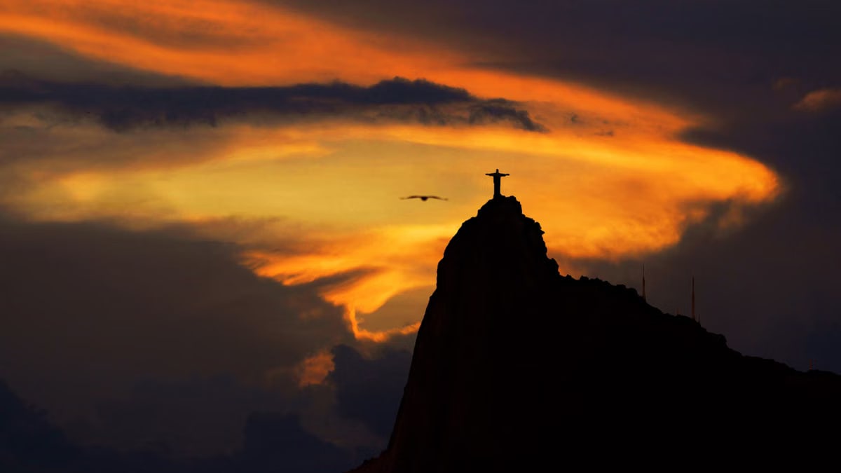 A captivating sunset silhouette of Christ the Redeemer in Rio de Janeiro, Brazil, exuding tranquility and beauty.
